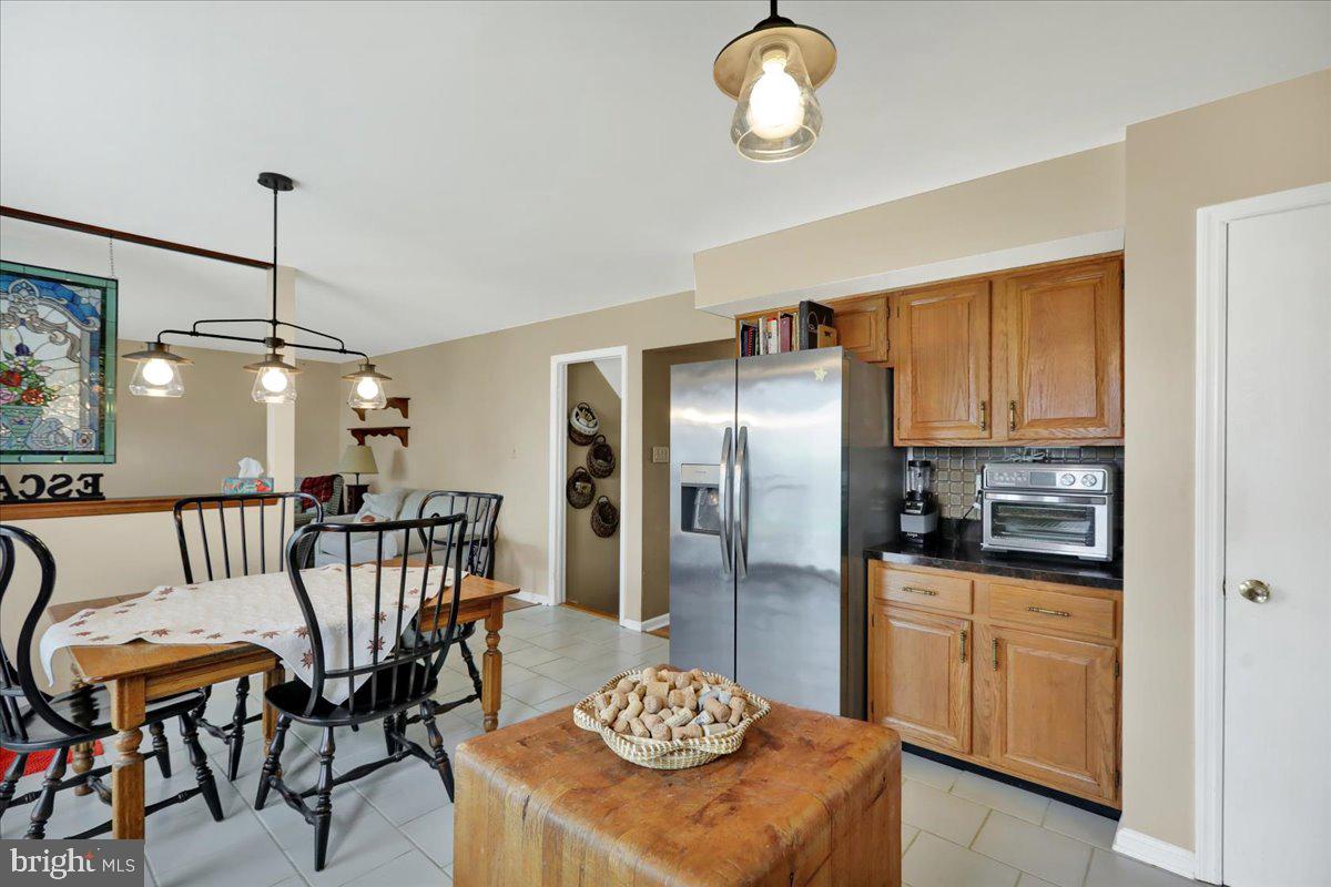 1839 Shellbark Drive Reading, PA 19608 - Photo 11 of 32 a kitchen with stainless steel appliances granite countertop a kitchen island a table and chairs in it