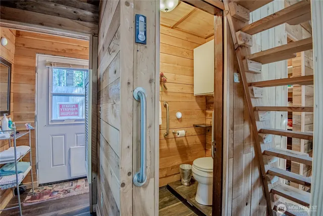 a bathroom with a glass door shower and a sink