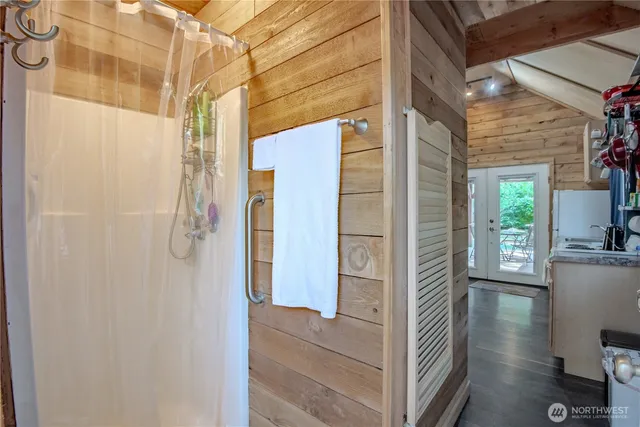 a bathroom with a shower and a sink