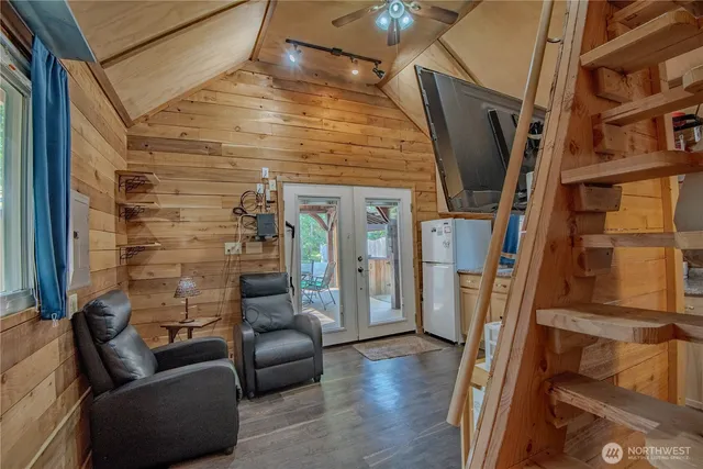 a view of a livingroom with furniture and a hallway