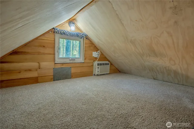 a view of an empty room with a windows and stairs