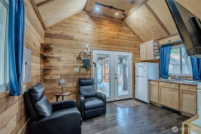 a living room with stainless steel appliances furniture and a fireplace