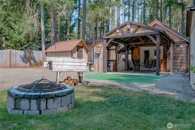 a view of a house with backyard and sitting area