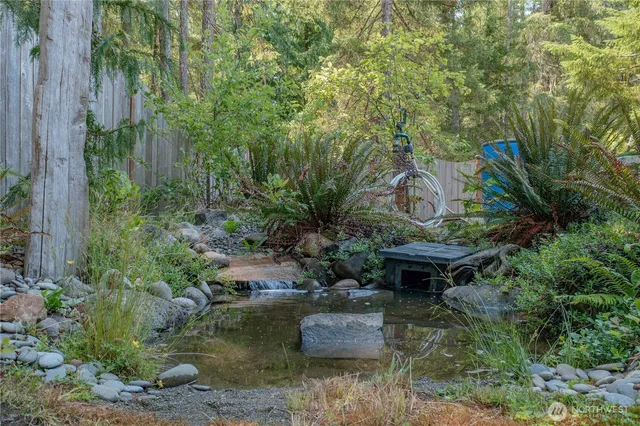 a view of backyard with outdoor seating and green space