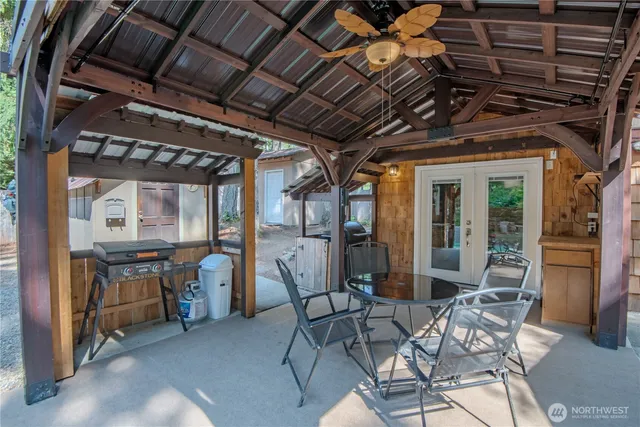 a view of a porch with furniture and next to a yard