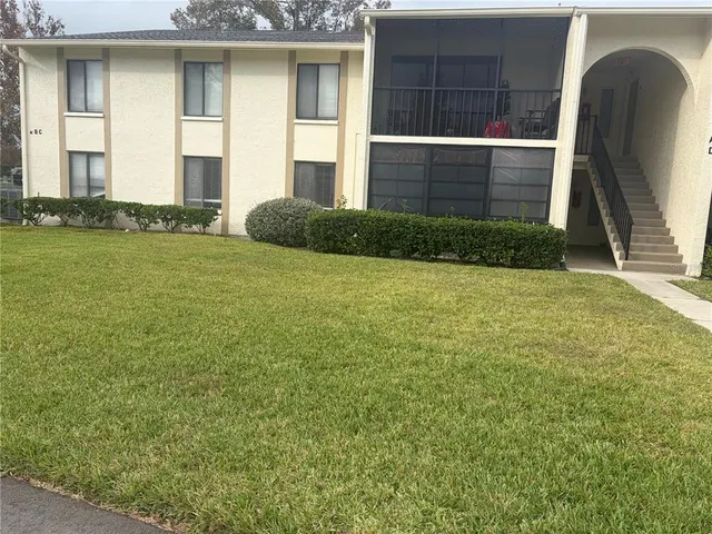 a view of a house with backyard and porch