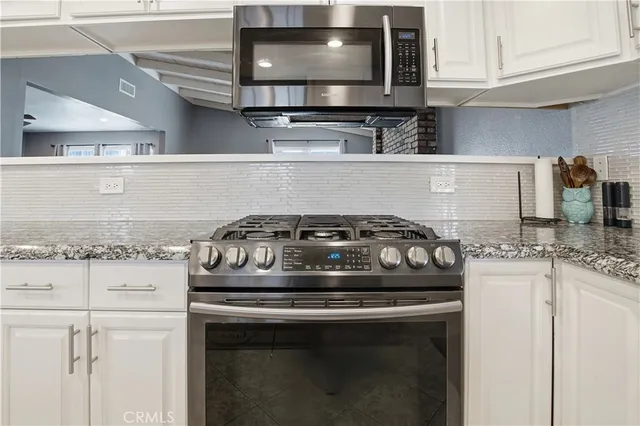 a bathroom with a toilet and a shower curtain