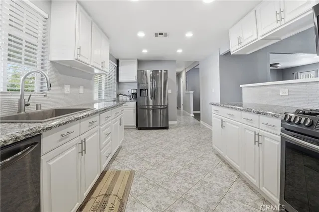 a view of a house with a yard and a large tree