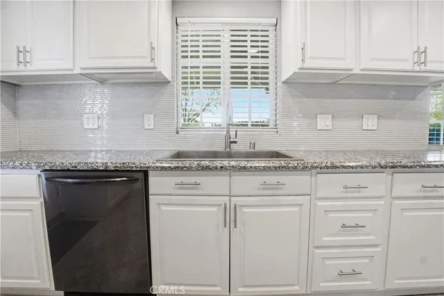 a view of a house with a big yard and large trees