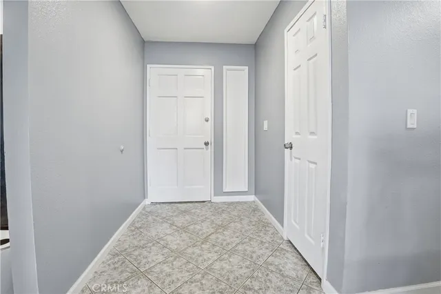 a view of a white house with a yard and sitting area