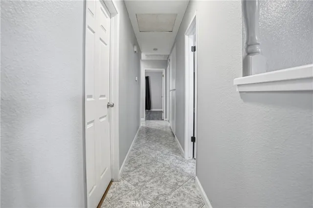 a view of a house with a big yard and large trees