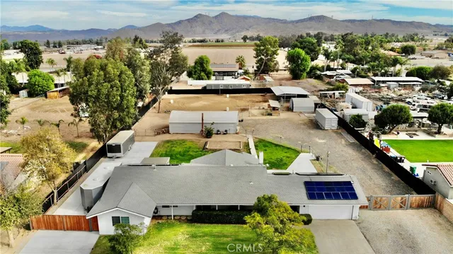 an aerial view of a house with a garden and lake view