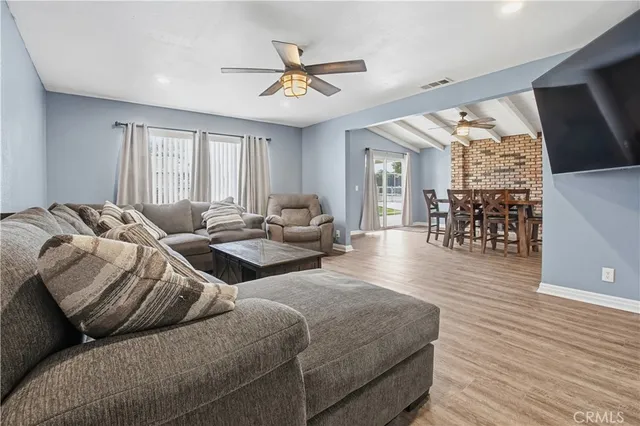 a kitchen with stainless steel appliances granite countertop a stove top oven a sink a dining table and chairs