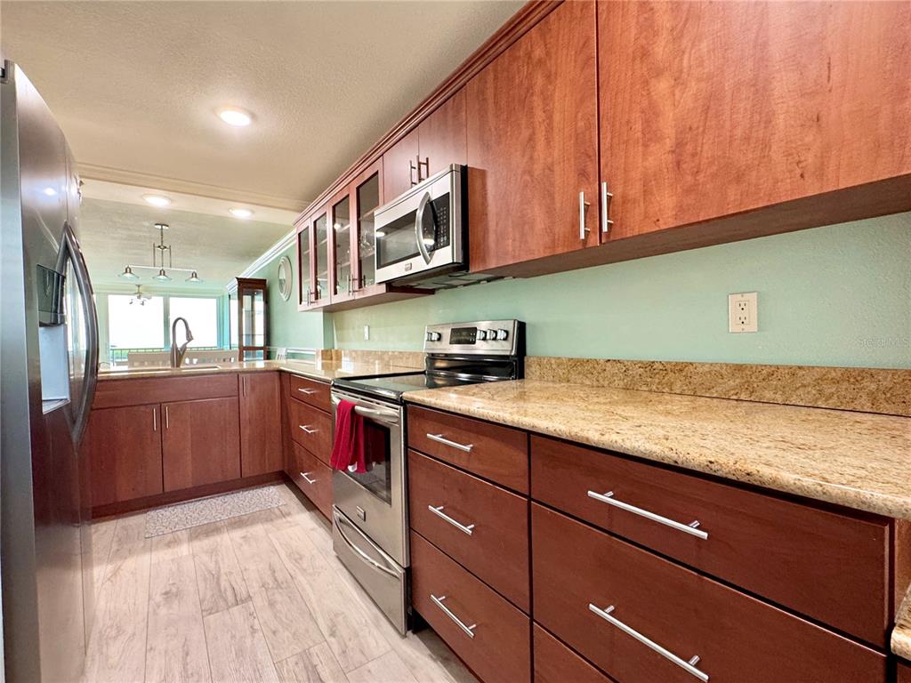 4620 Bay Boulevard, Unit 1145 Port Richey, FL 34668 - Photo 12 of 47 a kitchen with stainless steel appliances granite countertop a sink and cabinets