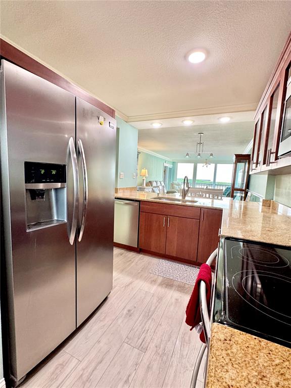 4620 Bay Boulevard, Unit 1145 Port Richey, FL 34668 - Photo 13 of 47 a kitchen with stainless steel appliances granite countertop a refrigerator a sink a stove and island