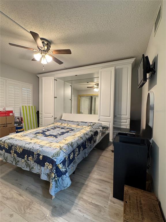 4620 Bay Boulevard, Unit 1145 Port Richey, FL 34668 - Photo 17 of 47 a bedroom with a bed and a chandelier