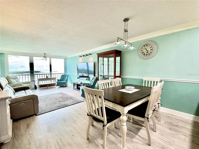 a living room with furniture and large windows