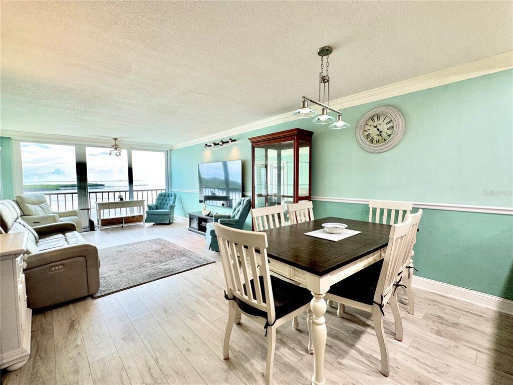 4620 Bay Boulevard, Unit 1145 Port Richey, FL 34668 - Photo 21 of 47 a dining room with furniture a window and wooden floor