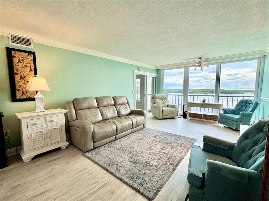 4620 Bay Boulevard, Unit 1145 Port Richey, FL 34668 - Photo 22 of 47 a living room with furniture and large windows