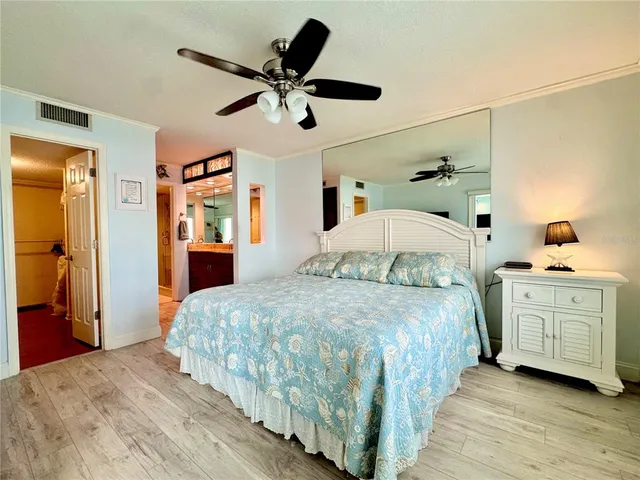 a bedroom with furniture and flat screen tv