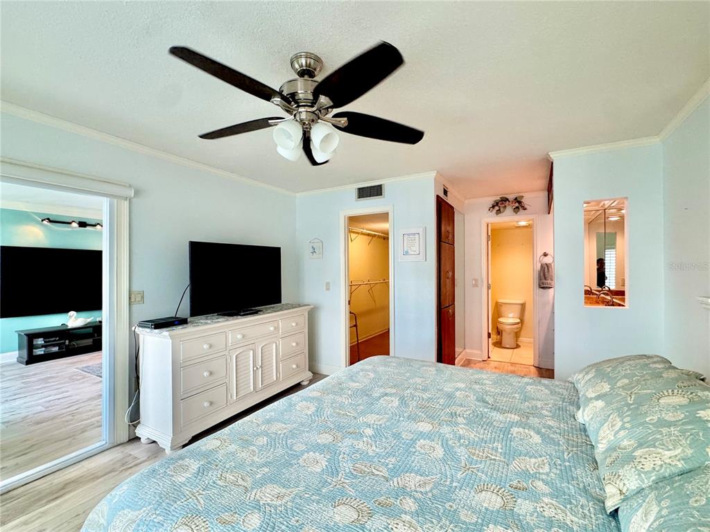4620 Bay Boulevard, Unit 1145 Port Richey, FL 34668 - Photo 28 of 47 a bedroom with furniture and flat screen tv