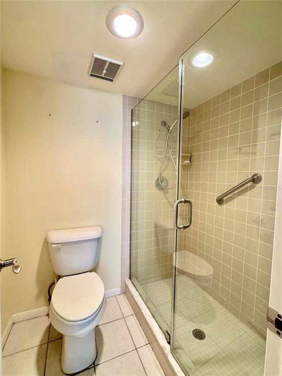 4620 Bay Boulevard, Unit 1145 Port Richey, FL 34668 - Photo 31 of 47 a bathroom with a toilet and a shower