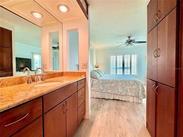 a bedroom with a large bed and a flat screen tv