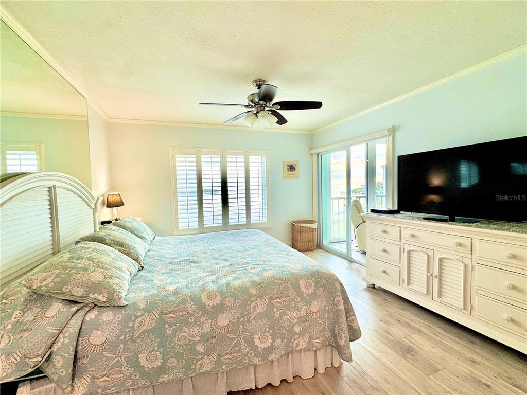 4620 Bay Boulevard, Unit 1145 Port Richey, FL 34668 - Photo 33 of 47 a bedroom with a large bed and a flat screen tv
