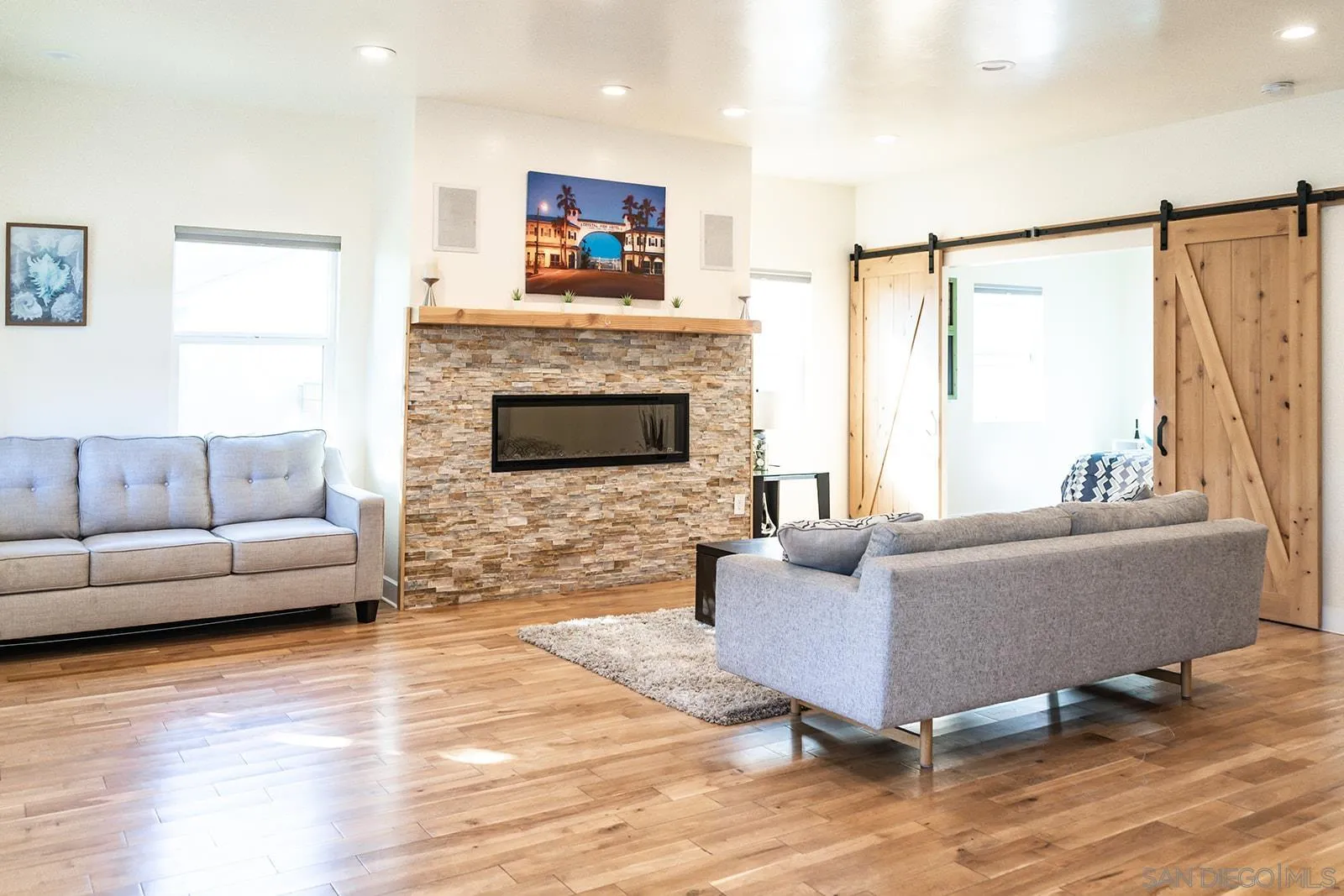 1220 Emerald Street San Diego, CA 92109 - Photo 15 of 19 a living room with furniture and a fireplace
