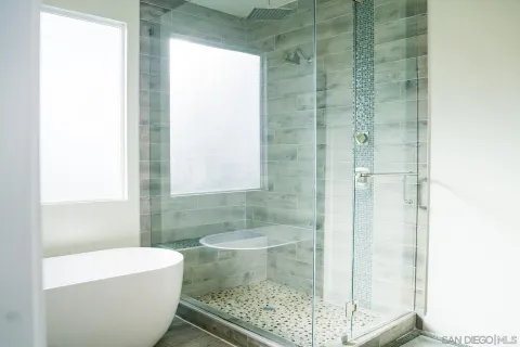 a bathroom with a tub and shower