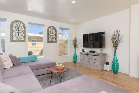 a living room with furniture and a flat screen tv