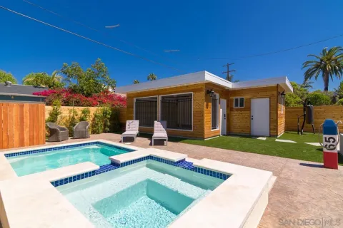 a view of a house with swimming pool and a yard