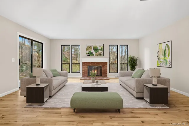a living room with furniture large window and wooden floor