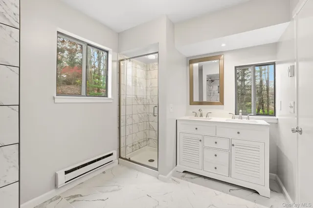 an empty room with windows cabinet and mirror