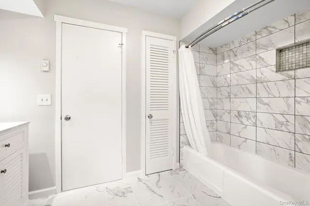 a bathroom with a bathtub and shower