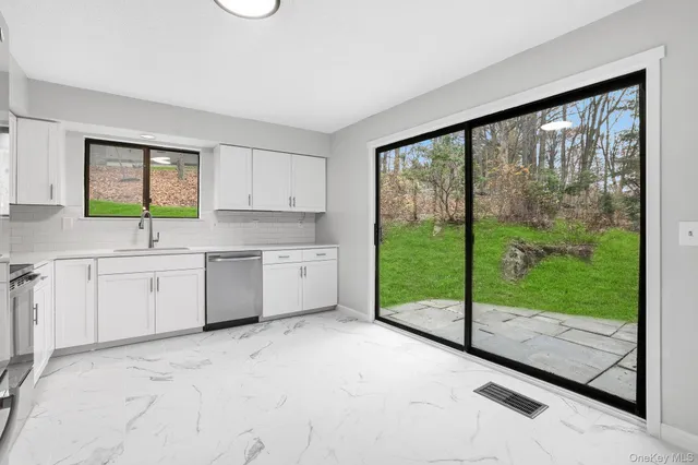a kitchen with a large window in it and sink