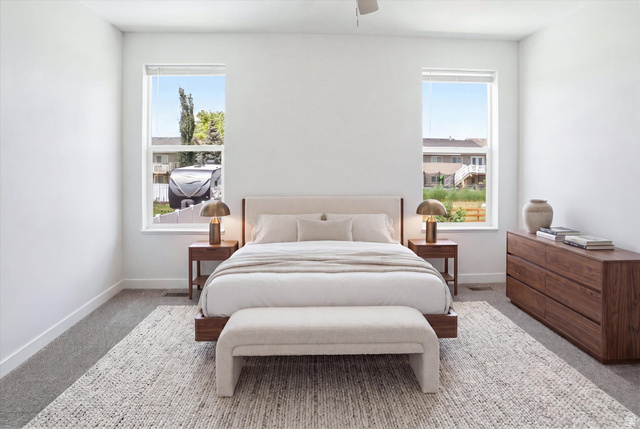 3636 West 910 South Syracuse, UT 84075 - Photo 5 of 70 Bright bedroom featuring two large windows, white walls, and gray carpet