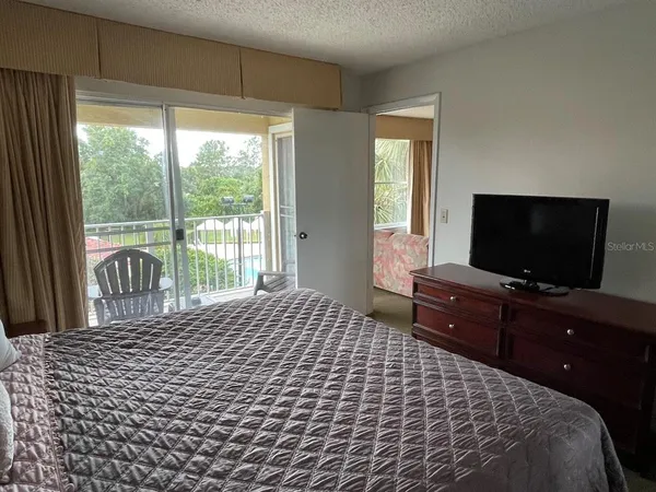 a bedroom with a bed and a flat screen tv