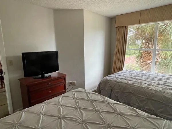 a bedroom with a bed and a flat screen tv