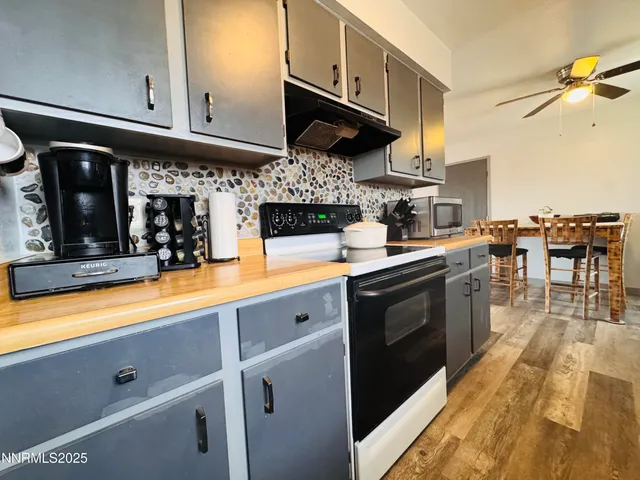 a kitchen with stainless steel appliances granite countertop a sink a stove and cabinets