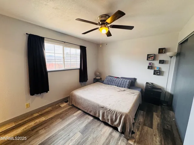 a bedroom with a bed and a large window