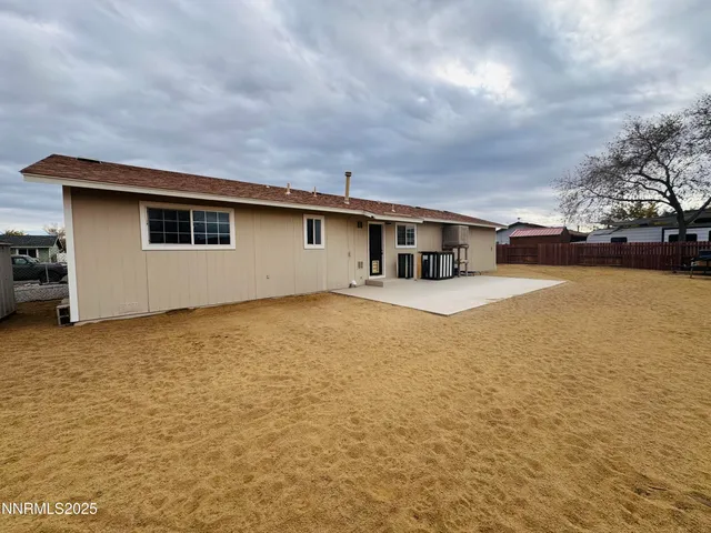 a house view with swimming pool and brick wall