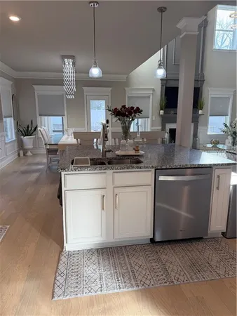 a living room with furniture a fireplace and a window