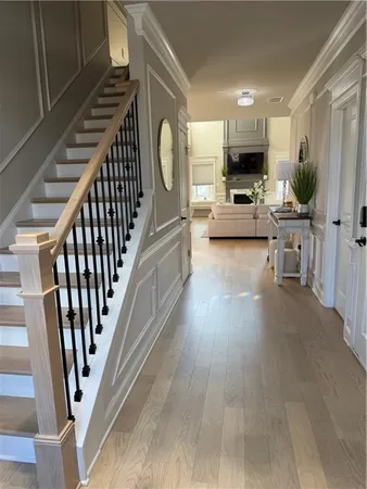 a view of a hallway and a livingroom with furniture