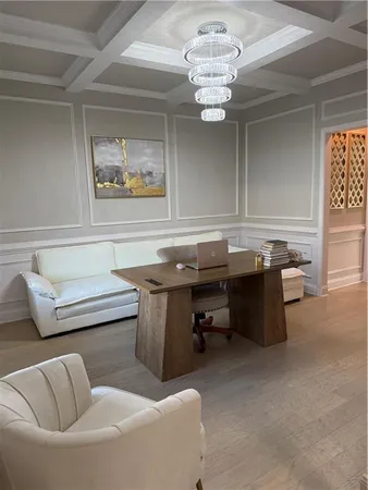 a kitchen with stainless steel appliances a stove a sink a microwave a refrigerator and white cabinets