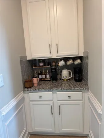 a kitchen with a sink a counter space cabinets and stainless steel appliances