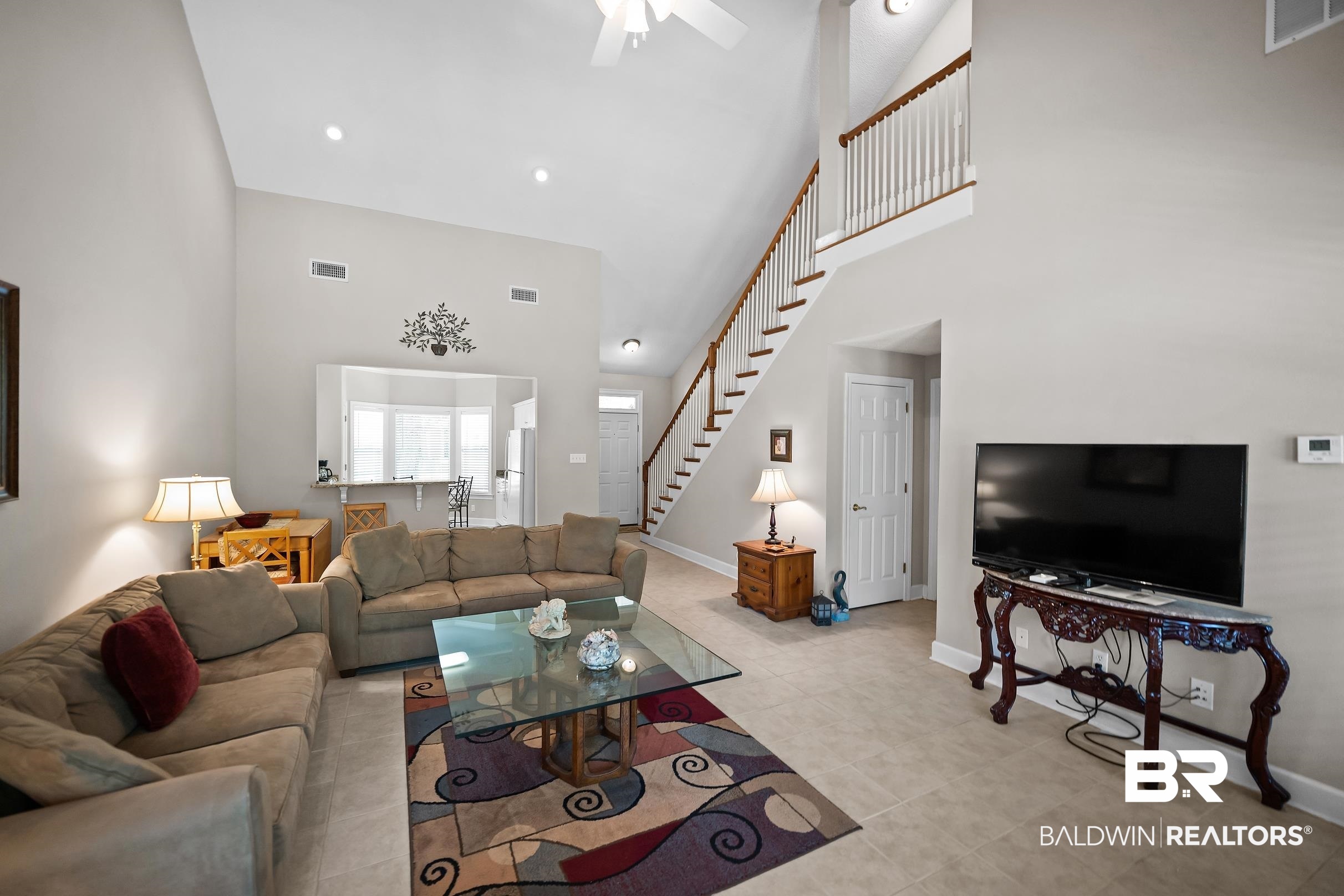 430 West Fort Morgan Road, Unit 704 Gulf Shores, AL 36542 - Photo 6 of 35 Spacious living area featuring high vaulted ceilings, recessed lighting, and tile flooring