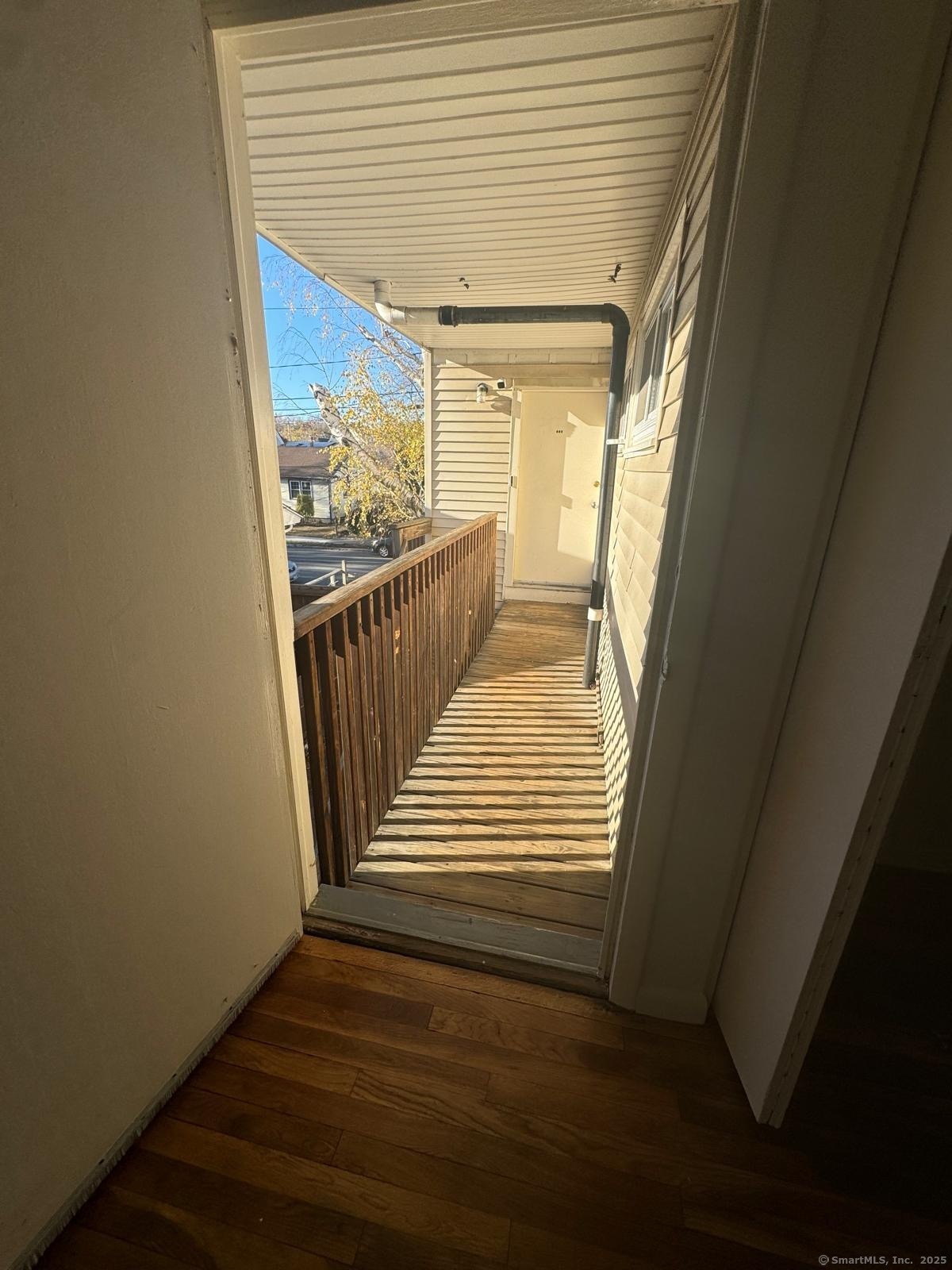 155 McKinley Avenue, Unit 15A Bridgeport, CT 06606 - Photo 2 of 5 a view of a hallway with wooden floor and staircase