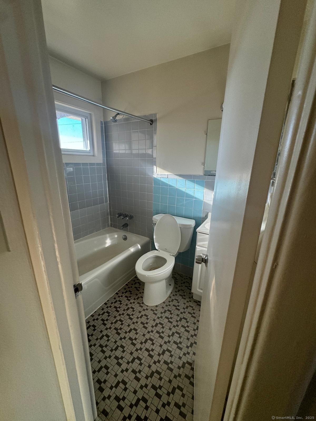 155 McKinley Avenue, Unit 15A Bridgeport, CT 06606 - Photo 4 of 5 a bathroom with a bathtub and a toilet