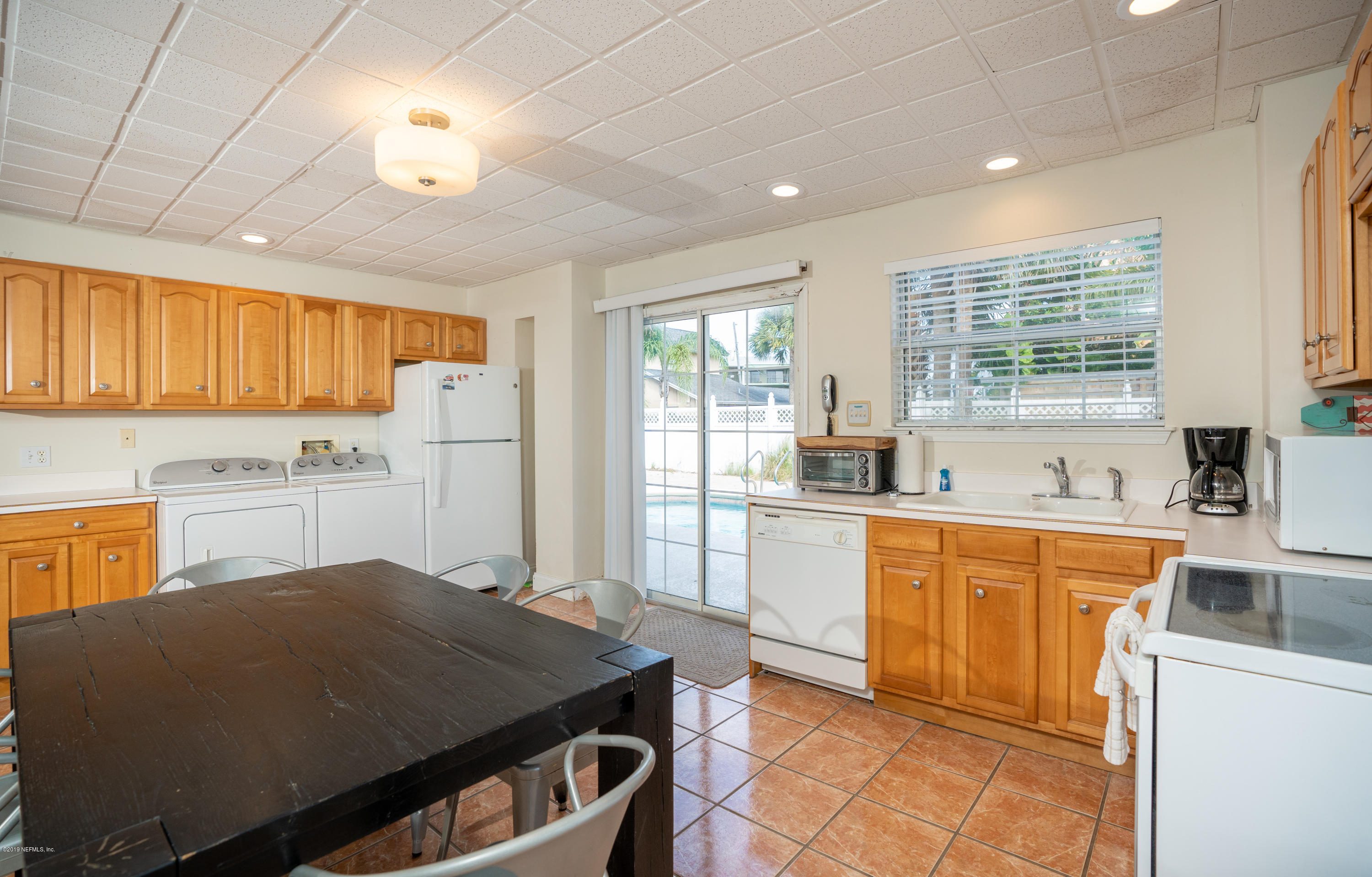 4 3rd Street St. Augustine, FL 32080 - Photo 11 of 47 a kitchen with a stove a sink dishwasher a refrigerator and cabinets with wooden floor